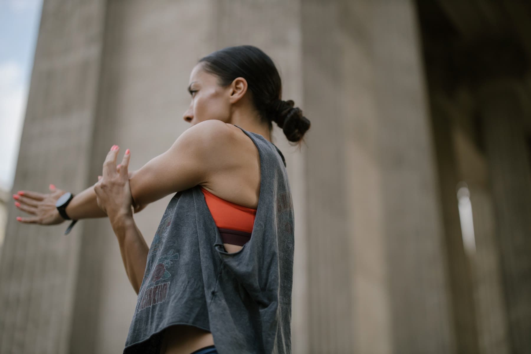 Athlete stretching outdoors in the city