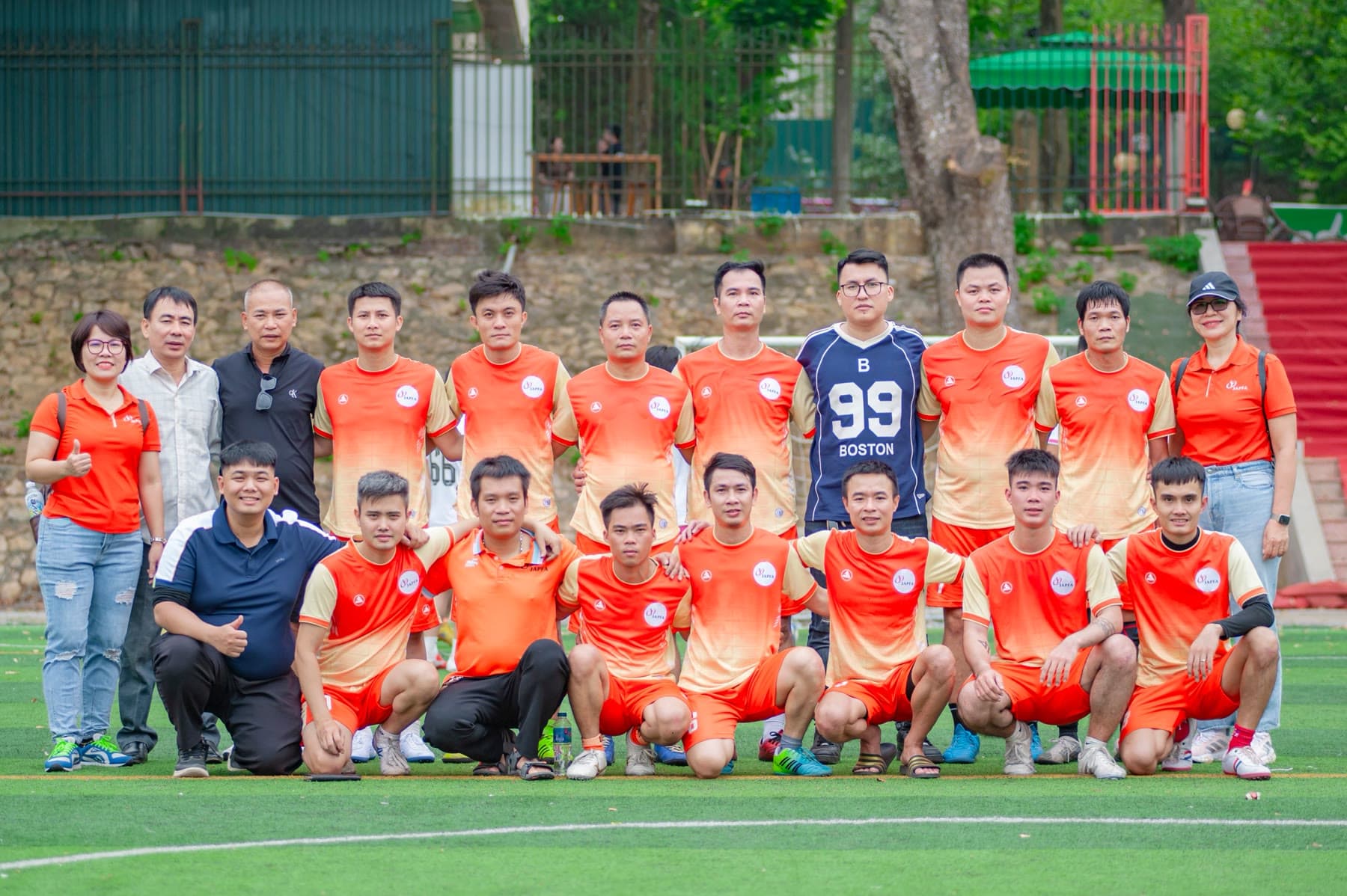 Large sports team posing together for a group photo